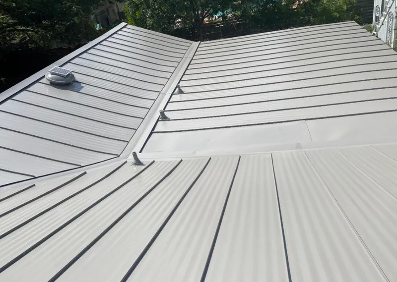 Solar attic fan installed on a metal roof for Roof Ventilation in Genoa